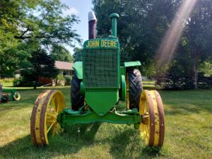 Green vintage Farm Tractor on the front lawn