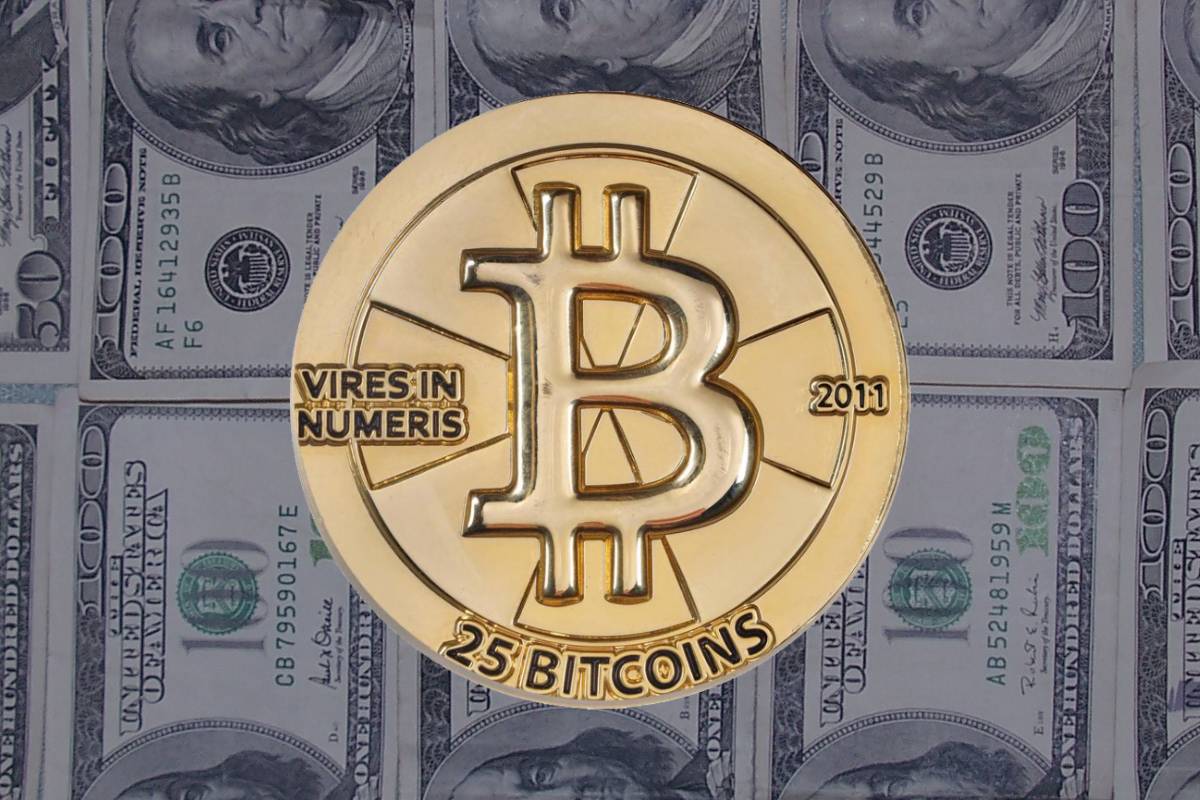 Bitcoin with 100-dollar American bills in the background