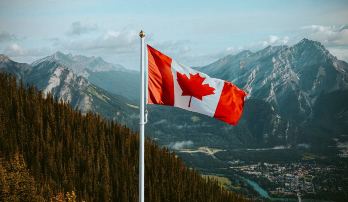 Flag flying over the Canadian Rocky Mountains